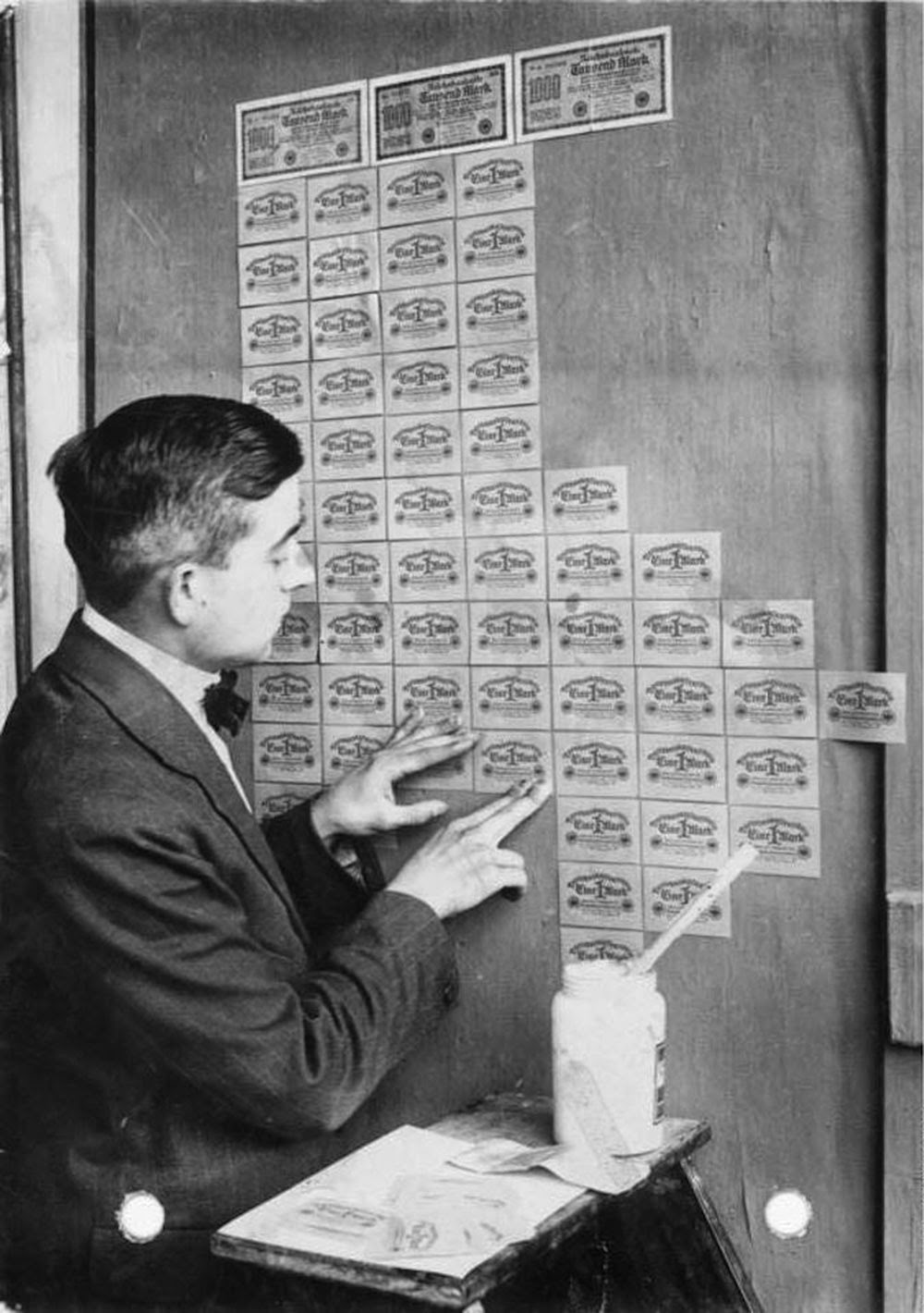 A person using bills as wallpaper during German hyperinflation, 1923
